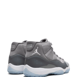 High-quality replica sneakers featuring the Nike Air Jordan 11 Retro High Top design, showcasing a sleek black and white colorway with textured detailing and the iconic Jumpman logo, perfect for sneaker enthusiasts.