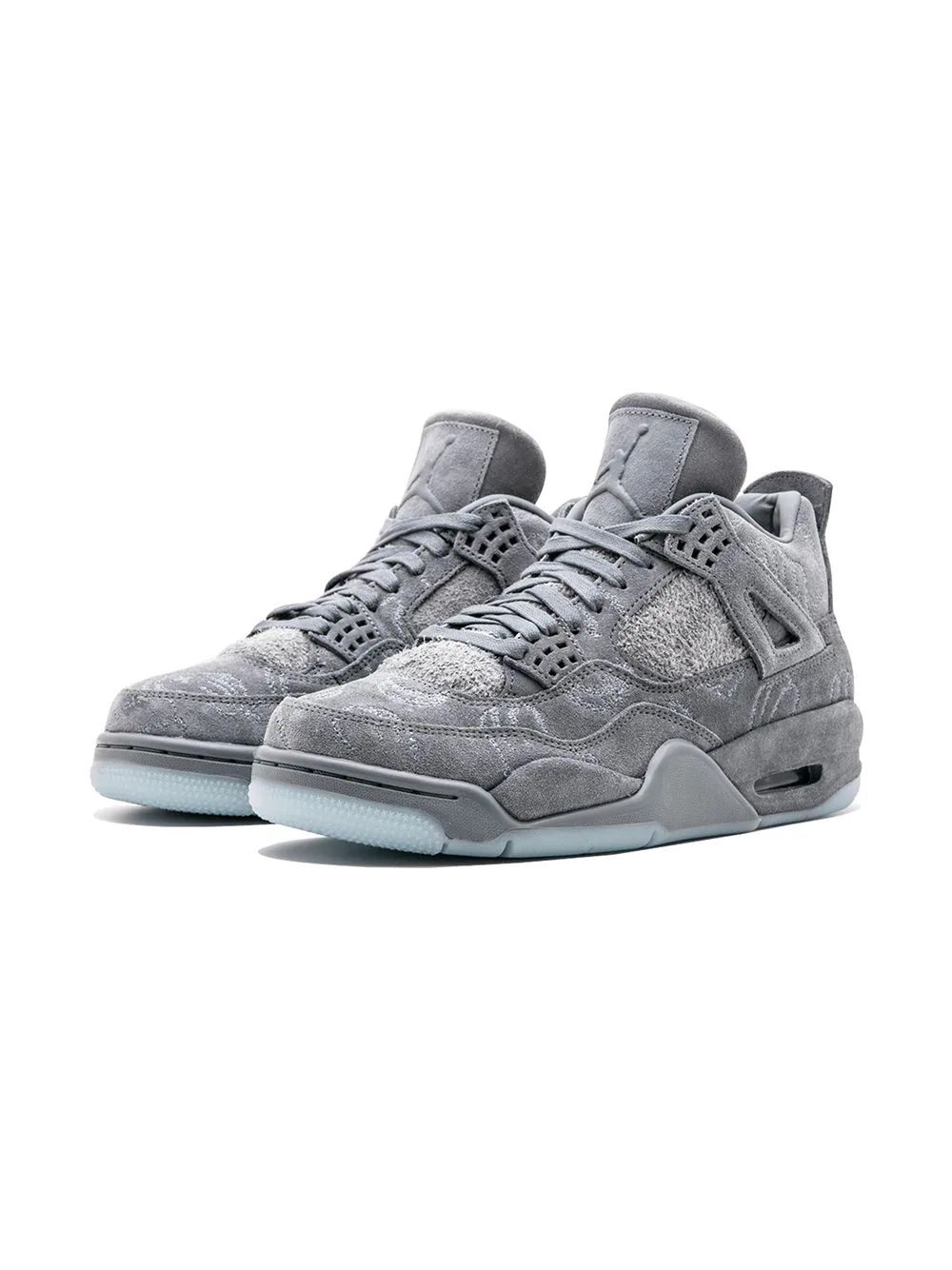Close-up view of the Nike Air Jordan 4 Retro Kaws sneakers featuring a unique grey suede upper, signature Kaws artwork, and iconic Air Jordan branding, perfect for sneaker collectors and streetwear enthusiasts.