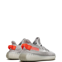 High-quality replica sneakers featuring the Adidas Yeezy Boost 350 V2 Tail Light model, showcasing a vibrant orange stripe and a textured black upper for a stylish, modern look.