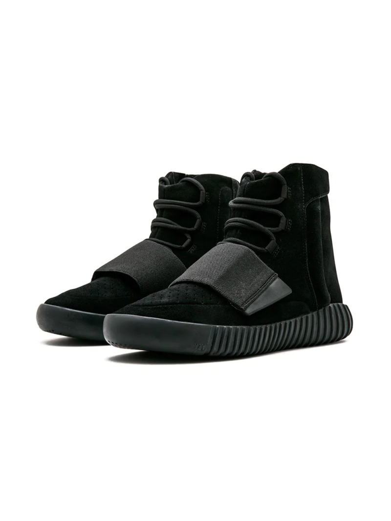 Alt Text: "High-quality replica sneakers featuring the Adidas Yeezy 750 Boost Triple Black model, showcasing a sleek black suede and leather upper with a distinctive high-top design and signature Boost sole."