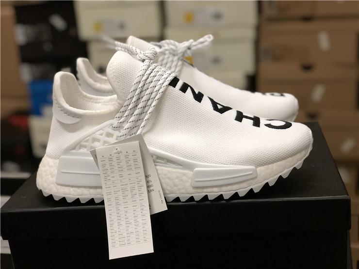 Adidas Human Race White replica sneakers featuring a sleek white upper, bold black lettering, and a comfortable boost sole, perfect for streetwear enthusiasts.