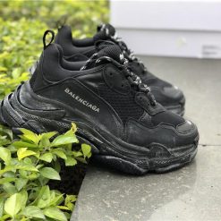 Balenciaga Triple S Trainer Black replica sneakers showcasing a stylish and trendy design, featuring a chunky silhouette, mixed materials, and a black colorway, perfect for fashion-forward individuals seeking high-quality footwear alternatives.