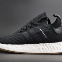 Adidas NMD R2 Primeknit Japan Black replica sneakers showcasing a sleek black design with a knitted upper, perfect for casual and athletic wear.