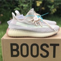 Adidas Yeezy Boost 350 V2 Citrin replica sneakers showcasing a sleek design with a primeknit upper in a light yellow tone, complemented by a translucent midsole and distinctive stripe detailing on the sides.