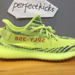 Adidas Yeezy Boost 350 V2 Semi Frozen Yellow replica sneakers featuring a vibrant yellow upper with black stripe detailing, designed for style and comfort.