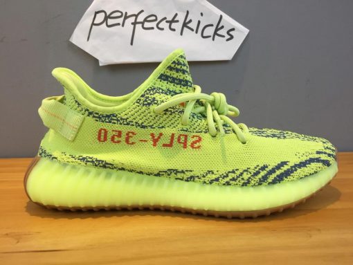 Adidas Yeezy Boost 350 V2 Semi Frozen Yellow replica sneakers featuring a vibrant yellow upper with black stripe detailing, designed for style and comfort.
