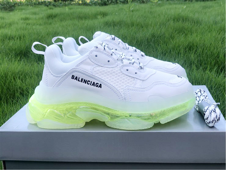 SEO Alt Text: "High-quality replica sneakers featuring the Balenciaga Triple S Clear Sole in a stylish white and fluo yellow colorway. These trendy shoes showcase a chunky design with a distinctive clear sole, perfect for fashion-forward sneaker enthusiasts."