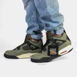 Undefeated Air Jordan 4 replica sneakers featuring a unique colorway, premium materials, and intricate detailing for sneaker enthusiasts and collectors.