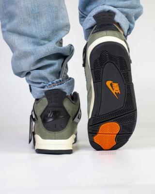 Undefeated Air Jordan 4 replica sneakers featuring a stylish design with a unique colorway and premium materials for sneaker enthusiasts and collectors.