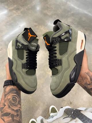 Undefeated Air Jordan 4 replica sneakers showcasing a distinct colorway and premium craftsmanship, perfect for sneaker enthusiasts seeking high-quality alternatives.