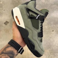 Undefeated Air Jordan 4 replica sneakers showcasing the iconic design with premium materials, featuring a unique colorway and details that capture the essence of the original.
