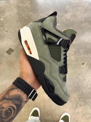 Undefeated Air Jordan 4 replica sneakers showcasing the iconic design with premium materials, featuring a unique colorway and details that capture the essence of the original.