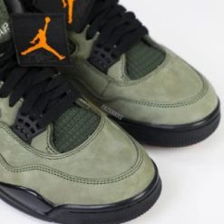 Undefeated Air Jordan 4 replica sneakers featuring a stylish design with a blend of military green and black accents, showcasing premium materials and attention to detail for sneaker enthusiasts.