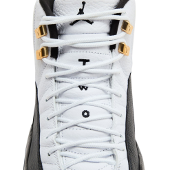 High-quality replica sneakers featuring the Air Jordan 12 Taxi design, showcasing a stylish black and white colorway with iconic gold accents.