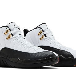Air Jordan 12 Taxi replica sneakers featuring a classic black and white colorway with hints of yellow, showcasing premium materials and attention to detail for sneaker enthusiasts.