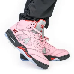 Awake NY Air Jordan 5 Arctic Pink replica sneakers featuring a stylish design with a soft pink upper, classic silhouette, and unique branding details, perfect for sneaker enthusiasts and collectors.