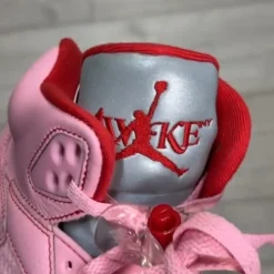 High-quality replica sneakers featuring the Awake NY Air Jordan 5 in a vibrant pink colorway, showcasing intricate detailing and stylish design elements.