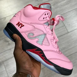 Awake NY Air Jordan 5 Pink replica sneakers displayed prominently, showcasing a unique pink colorway, high-quality craftsmanship, and stylish design elements perfect for sneaker enthusiasts.